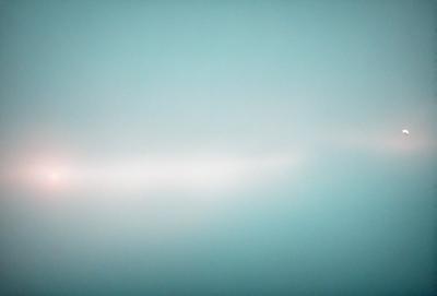 The primary subject of the image is a large, empty, and dark blue sky. The setting is a vast, open space with no visible landmarks or objects. The visual style is a natural, untouched landscape, and the colors and mood are serene and tranquil.