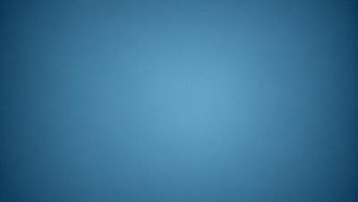 The primary subject of the image is a blue sky. The setting is a vast, open space with no visible landmarks or objects. The visual style is a simple, clean blue background, which gives the image a calm and serene atmosphere.