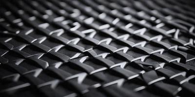 The primary subject of the image is a close-up of a black and white patterned fabric. The setting is a black background, which contrasts with the patterned fabric. The visual style is a combination of a photo and a digital art, as the pattern appears to be a digital design. The colors and mood of the image are predominantly black and white, giving it a classic and timeless appearance.