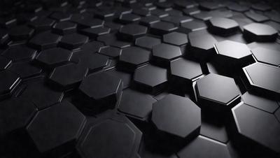 The primary subject of the image is a close-up of a black and white patterned surface, which appears to be a textured wall or a black and white tile. The setting is a dark room, and the visual style is a black and white photo. The dominant colors are black and white, and the overall atmosphere is somewhat mysterious and intriguing.