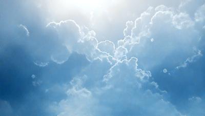 The primary subject of the image is a cloudy blue sky filled with clouds. The setting is a vast, open sky, and the visual style is a natural, outdoor atmosphere. The colors and mood of the image are predominantly blue and serene, creating a peaceful and tranquil scene.