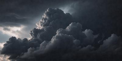 The primary subject of the image is a large, dark cloud with a dramatic, stormy appearance. The cloud is the main focus of the image, and it is set against a dark, cloudy sky. The visual style of the image is a photo, capturing the cloud's dramatic presence in the sky. The colors and mood of the image are dark and moody, with the cloud looming over the landscape.