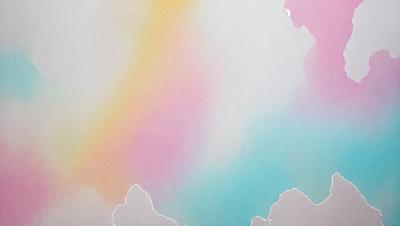 The primary subject of the image is a painting of a rainbow. The setting is a white wall, and the visual style is a painting. The dominant colors in the painting are pink, blue, and white, creating a vibrant and cheerful atmosphere.