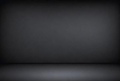 The primary subject of the image is a black background. The setting is a dark room, and the visual style is a black and white photo. The colors and mood of the image are predominantly dark and moody.