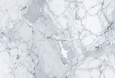 The image features a marble wall with a white and gray color scheme. The marble wall is textured and has a natural, earthy appearance. The primary subject of the image is the marble wall, which serves as the main object, scene, or focus of the image. The setting or background of the image is the marble wall, which is the primary visual element in the scene. The visual style of the image is a close-up of the marble wall, showcasing its texture and natural beauty. The colors and mood of the image are predominantly white and gray, creating a calm and serene atmosphere.