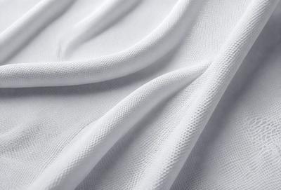 The primary subject of the image is a white sheet of fabric. The setting is a white background, which creates a clean and minimalist appearance. The visual style is a close-up of the fabric, showcasing its texture and details. The colors and mood of the image are predominantly white, giving it a calm and serene atmosphere.
