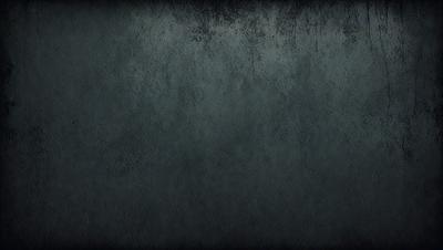 The primary subject of the image is a large, dark grey wall. The setting is a concrete wall, and the visual style is a photo. The colors and mood of the image are dark and moody, with the grey wall being the dominant color.