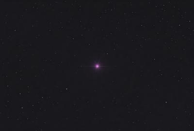 The primary subject of the image is a single star, which is the main object in the scene. The setting is a dark, star-filled sky, with the star being the focal point. The visual style is a black and white image, which adds a sense of depth and contrast to the scene. The colors and mood of the image are predominantly dark and moody, with the star being the only bright and prominent element in the sky.