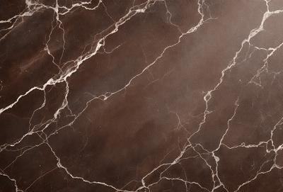 The primary subject of the image is a marble countertop with a brown and white pattern. The setting is a kitchen, and the visual style is a close-up of the countertop. The colors and mood of the image are warm and natural, with the brown and white marble creating a sense of elegance and sophistication.