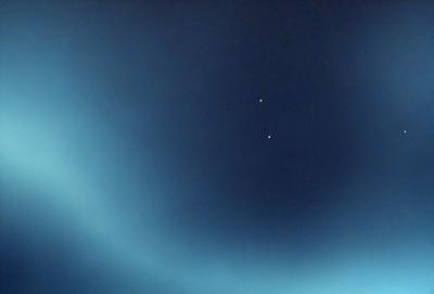 The primary subject of the image is the night sky, which is filled with stars. The setting is a dark, starry night, with the sky being the main focus of the image. The visual style is a photo, capturing the beauty of the night sky. The colors and mood of the image are predominantly dark, with the stars being the main source of light and creating a serene atmosphere.