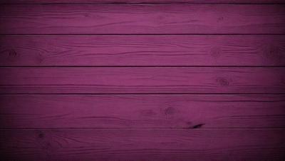 The primary subject of the image is a purple wooden wall. The setting is a room with a wooden floor. The visual style is a close-up of the wooden wall, which gives a sense of texture and depth. The colors and mood of the image are predominantly purple, creating a calm and serene atmosphere.