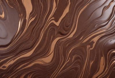 The primary subject of the image is a close-up of a chocolate-covered surface, possibly a cake or a piece of chocolate art. The setting is a brown background, which complements the rich color of the chocolate. The visual style appears to be a close-up of the chocolate, showcasing its texture and details. The colors and mood of the image are predominantly brown, creating a warm and inviting atmosphere.