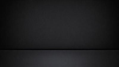 The primary subject of the image is a black background. The setting is a dark room, and the visual style is a black and white photo. The colors and mood are dark and moody, creating a dramatic atmosphere.