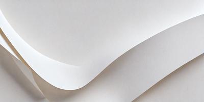 The primary subject of the image is a white sheet of paper. The setting is a white background, which creates a clean and minimalist appearance. The visual style is a close-up of the paper, emphasizing its texture and details. The colors and mood are predominantly white, giving the image a calm and serene atmosphere.