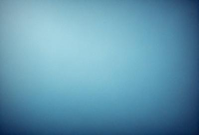 The primary subject of the image is a large, empty, and dark blue sky. The setting is a vast, open space with no visible landmarks or objects. The visual style is a natural, untouched, and unaltered representation of the sky. The colors and mood convey a sense of tranquility and vastness.