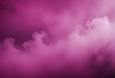 The image features a pink cloudy sky with a purple hue. The primary subject is the cloudy sky, which is the main focus of the image. The setting is the sky, and the visual style is a photo. The colors and mood of the image are predominantly pink and purple, creating a soft and dreamy atmosphere.