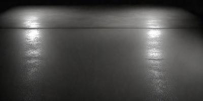 The primary subject of the image is a large body of water, which appears to be a lake. The setting is a dark, black background, which contrasts with the water. The visual style is a black and white photo, giving the image a classic and timeless appearance. The colors and mood of the image are predominantly dark, with the water being the main focal point.