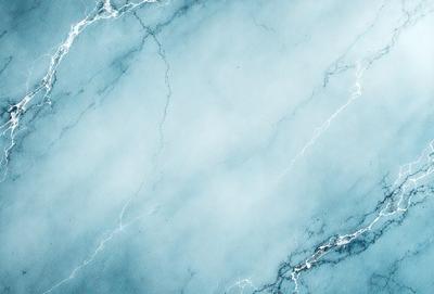 The primary subject of the image is a marble-like surface with a blue and white color scheme. The setting is a bathroom, as indicated by the presence of a sink. The visual style is a combination of a photo and a drawing, creating a unique and artistic representation of the marble surface. The colors and mood of the image are calming and serene, with the blue and white tones evoking a sense of tranquility and sophistication.