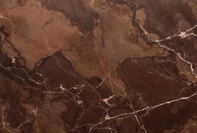 The primary subject of the image is a marble surface with a brown and white color scheme. The setting is a room with a brown and white marble wall, which adds a sense of elegance and sophistication to the space. The visual style of the image is a close-up of the marble wall, showcasing its intricate patterns and textures. The colors and mood of the image are warm and inviting, creating a comfortable and luxurious atmosphere.