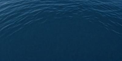 The primary subject of the image is a large body of water, which appears to be a deep blue ocean. The setting is a vast expanse of water, with no visible land or other objects in the background. The visual style of the image is a close-up of the water, showcasing its depth and color. The colors and mood of the image are predominantly blue, creating a serene and tranquil atmosphere.