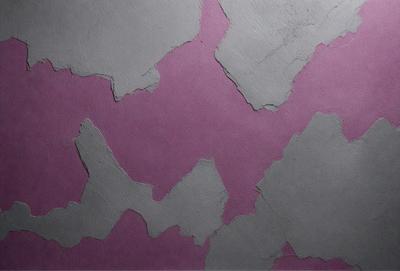 The primary subject of the image is a purple wall with a pattern of white and grey rocks. The setting is a room with a pink background. The visual style is a combination of photo and digital art, creating a unique and interesting pattern on the wall. The dominant colors are purple and grey, giving the wall a calm and soothing atmosphere.