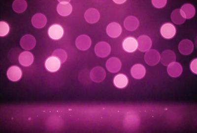 The primary subject of the image is a purple background with a pattern of pink lights. The setting is a dark room, and the visual style appears to be a digital art or illustration. The dominant colors are purple and pink, creating a warm and inviting atmosphere.