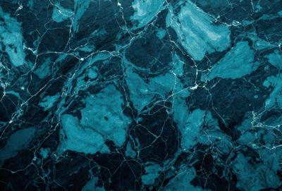 The primary subject of the image is a close-up of a blue marble wall. The setting is a dark room, and the visual style appears to be a photo. The dominant colors are blue and black, creating a moody atmosphere.