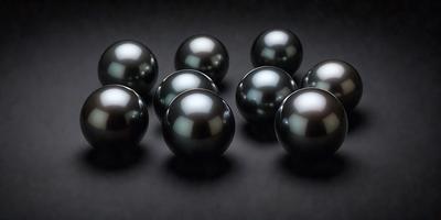 The primary subject of the image is a group of black pearls. They are arranged in a visually appealing manner, with some pearls overlapping each other. The setting is a black background, which provides a contrasting and elegant backdrop for the pearls. The visual style of the image is a close-up of the pearls, showcasing their unique shapes and textures. The colors and mood of the image are predominantly dark, with the black pearls being the main focus and creating a sense of sophistication and luxury.