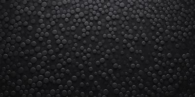 The primary subject of the image is a close-up of a black surface with a pattern of small circles. The setting appears to be a dark room, and the visual style is a black and white photo. The dominant colors are black and white, and the overall atmosphere is somewhat mysterious and intriguing.