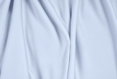 The primary subject of the image is a white cloth, which is the main object, scene, or focus of the image. The setting/background consists of a white background, which provides a clean and minimalistic environment. The visual style of the image is a photo, as it captures the details and textures of the white cloth. The colors and mood of the image are predominantly white, giving it a clean, simple, and serene atmosphere.