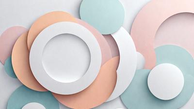 The primary subject of the image is a collection of white and colored paper circles. The setting is a white background, and the visual style appears to be a combination of photo and digital art. The circles are arranged in various shapes and sizes, creating a visually appealing and colorful display. The dominant colors in the image are white and the various colors of the paper circles, which contribute to a lively and vibrant atmosphere.