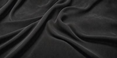 The primary subject of the image is a black fabric, which appears to be a piece of cloth or a curtain. The setting is a dark room, and the visual style is a close-up of the fabric. The colors and mood of the image are predominantly dark and moody, with the black fabric being the main focus.