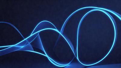 The primary subject of the image is a blue light, which appears to be a neon light or a blue laser. The light is shining in a dark room, creating a striking visual effect. The setting is a dark room, and the visual style is a close-up of the blue light. The colors and mood of the image are predominantly blue, creating a calm and serene atmosphere.