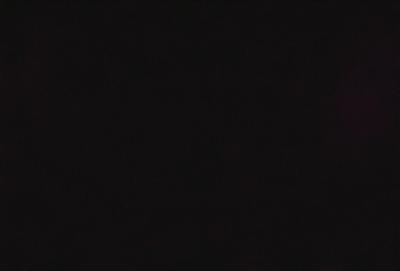 The image is a black and white photo of a dark, empty space. The primary subject is the darkness, which fills the entire frame. The setting is a void, with no visible background or environment. The visual style is a traditional black and white photo, which adds a sense of nostalgia and timelessness to the image. The colors and mood are predominantly dark and moody, creating a sense of mystery and intrigue.