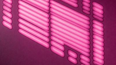 The primary subject of the image is a pattern of pink and white objects, which are likely to be candles. The setting is a purple background, which adds a contrasting color to the scene. The visual style of the image is a combination of a photo and digital art, as it appears to be a close-up of the candles on a purple surface. The colors and mood of the image are predominantly pink and white, creating a warm and inviting atmosphere.