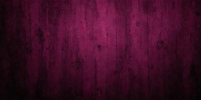 The primary subject of the image is a wooden surface with a purple hue. The setting is a wooden floor, and the visual style is a close-up of the wooden surface. The dominant colors are purple and brown, creating a warm and cozy atmosphere.