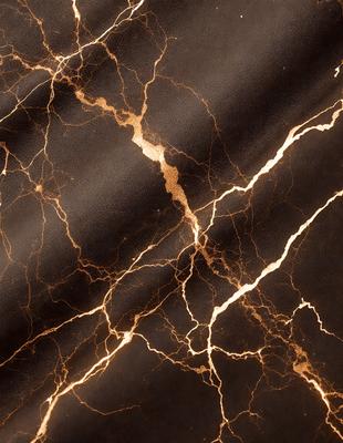 The primary subject of the image is a close-up of a marble surface with a gold-like pattern. The setting is a black background, which contrasts with the marble. The visual style is a photo, capturing the intricate details of the marble pattern. The colors and mood of the image are warm and luxurious, with the gold-like pattern adding a touch of sophistication.