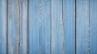 The primary subject of the image is a blue wooden wall with a peeling paint surface. The setting is a room with a blue wall, and the visual style is a close-up of the wall. The dominant colors are blue and white, and the overall atmosphere is somewhat aged and worn.