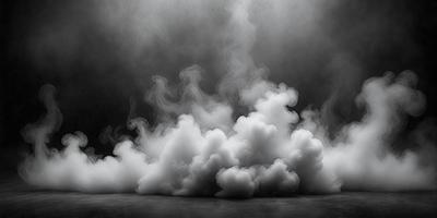The primary subject of the image is a cloud of smoke, which is the main object, scene, or focus of the image. The setting is a dark background, which creates a dramatic and moody atmosphere. The visual style is a black and white photo, giving the image a classic and timeless appearance. The colors and mood are dominated by the smoke, which appears as a dense and ominous presence in the scene.