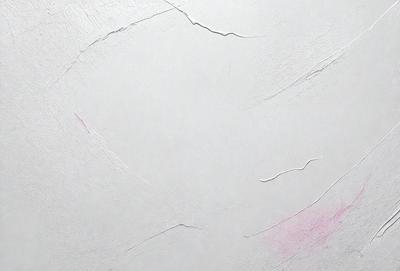 The primary subject of the image is a white wall with a pink smudge on it. The setting is a room with a white surface, and the visual style appears to be a photo. The dominant colors are white and pink, creating a warm and inviting atmosphere.
