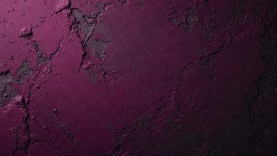 The primary subject of the image is a purple wall with a black background. The setting appears to be a dark room, possibly a dungeon or a cave. The visual style of the image is a close-up of the purple wall, which gives it a moody and dramatic appearance. The dominant colors in the image are purple and black, creating a striking contrast against the black background.