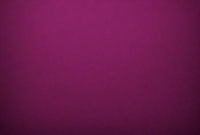 The primary subject of the image is a purple background. The setting is a dark room, and the visual style appears to be a photo. The dominant colors are purple and dark, creating a moody atmosphere.