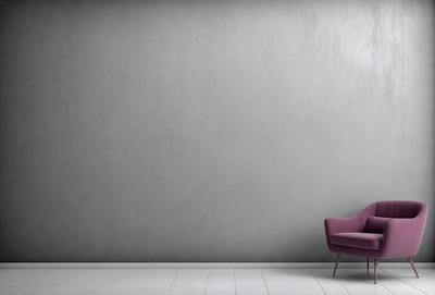 The primary subject of the image is a purple chair placed in a room with a white floor. The chair is positioned against a gray wall, which serves as the setting and background of the scene. The visual style of the image is a photo, capturing the chair and its surroundings in a realistic manner. The colors in the image are predominantly gray and purple, creating a calm and serene atmosphere.