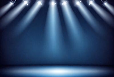 The primary subject of the image is a blue stage with a blue background. The stage is illuminated by a series of bright lights, creating a dramatic and captivating atmosphere. The visual style of the image is a photo, capturing the lighting and stage design in detail. The colors and mood of the image are predominantly blue, giving it a calm and serene feel.