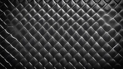 The primary subject of the image is a close-up of a black leather material, possibly a leather jacket or a leather-like surface. The setting is a black background, which emphasizes the leather material. The visual style is a close-up, focusing on the details of the leather. The colors and mood of the image are predominantly black, giving it a sleek and modern appearance.