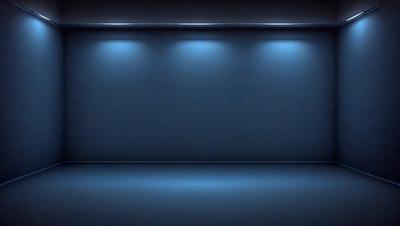 The primary subject of the image is a blue wall with a light shining on it. The setting is a dark room, and the visual style appears to be a photo. The dominant colors are blue and black, creating a moody atmosphere.