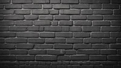 The primary subject of the image is a brick wall. The setting is a dark room, and the visual style is a black and white photo. The colors and mood of the image are dark and moody, creating a dramatic atmosphere.