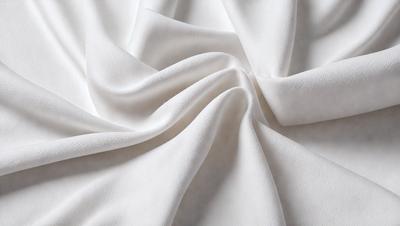 The primary subject of the image is a white sheet of fabric, which is the main object, scene, or focus of the image. The setting is a white background, which provides a clean and minimalistic environment. The visual style is a close-up of the fabric, showcasing its texture and details. The colors and mood of the image are predominantly white, giving it a clean, fresh, and serene atmosphere.