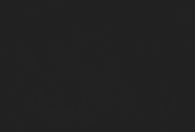 The primary subject of the image is a black background. The setting/background is a dark, empty space. The visual style is a black and white photo. The colors and mood are dark and moody.