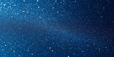 The primary subject of the image is a beautiful blue sky filled with bright stars. The setting is a night sky, and the visual style is a photo. The colors and mood of the image are predominantly blue and serene, creating a peaceful and tranquil atmosphere.